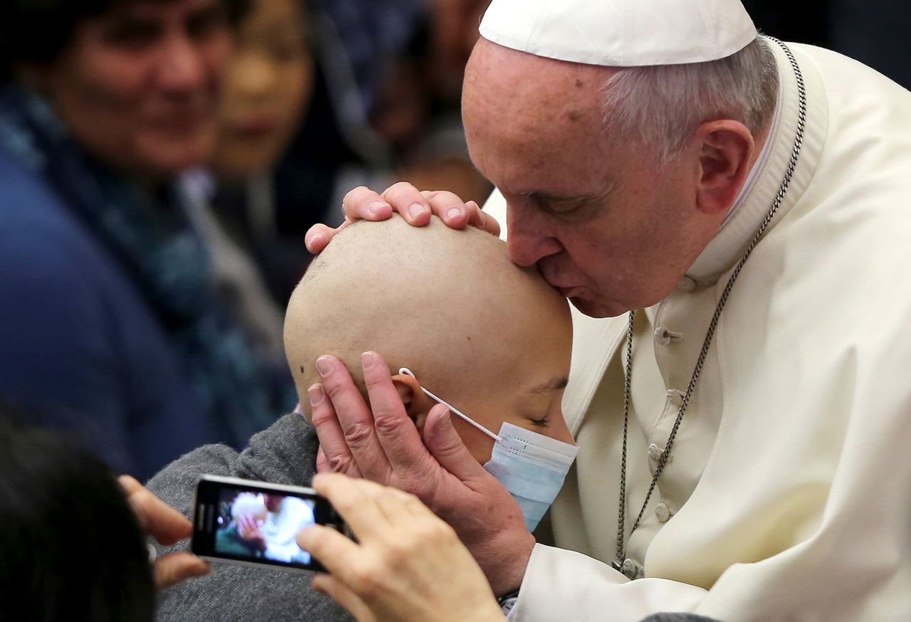 The Pope kisses a girl during a special audience at the Vatican in November 2014.