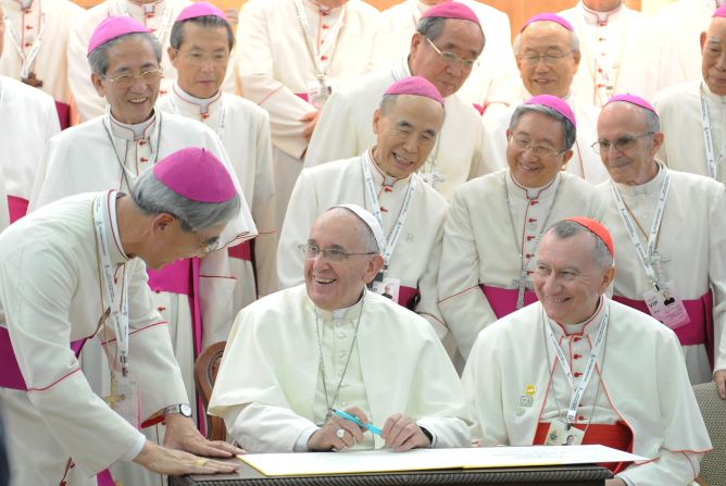 The Pope signs a guestbook while meeting with bishops in Seoul, South Korea, in August 2014.