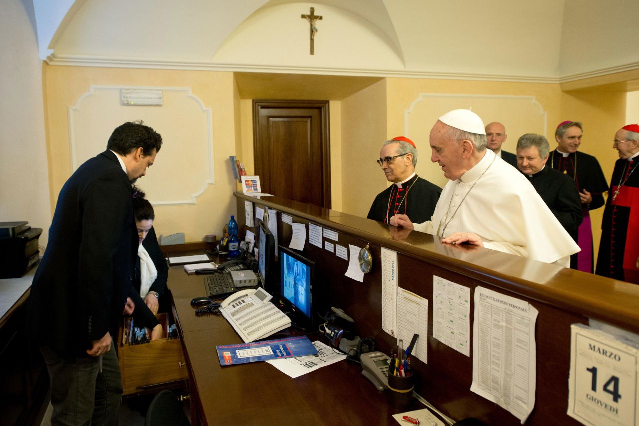 A day after his election, the Pope pays his lodging bill at the Paulus VI, where he stayed during conclave.