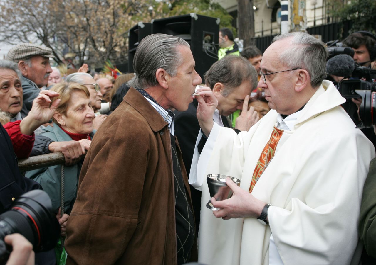 Francis gives holy communion to Roberto Bendini, Argentina's former army chief, in 2009.