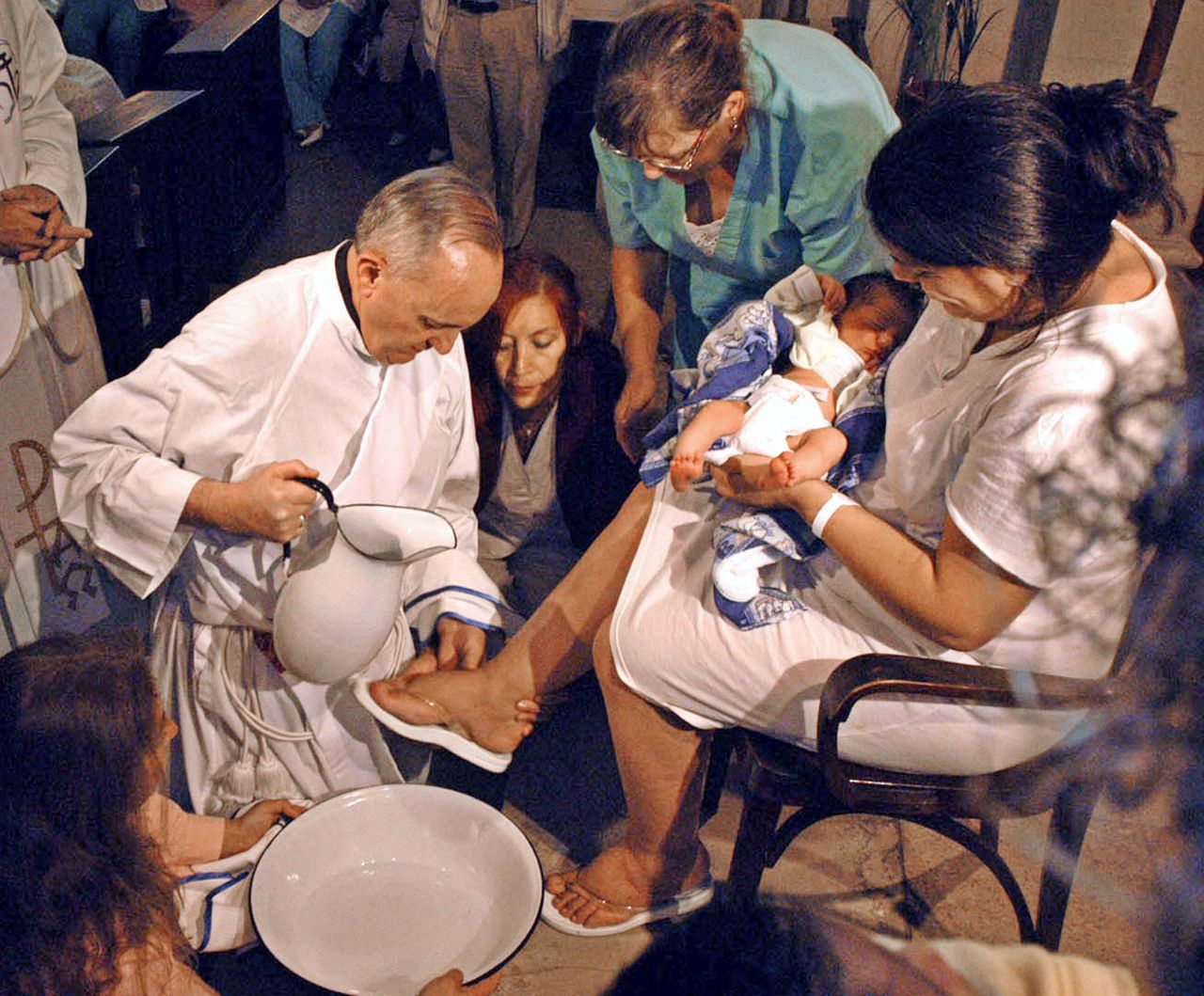 The future pope washes a woman's feet at a maternity hospital in Buenos Aires in 2005.