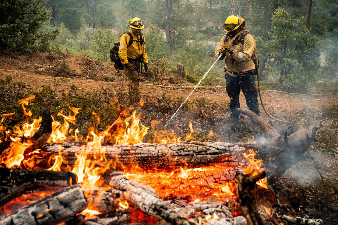 Firefighters mop up hot spots while battling California's Oak Fire.