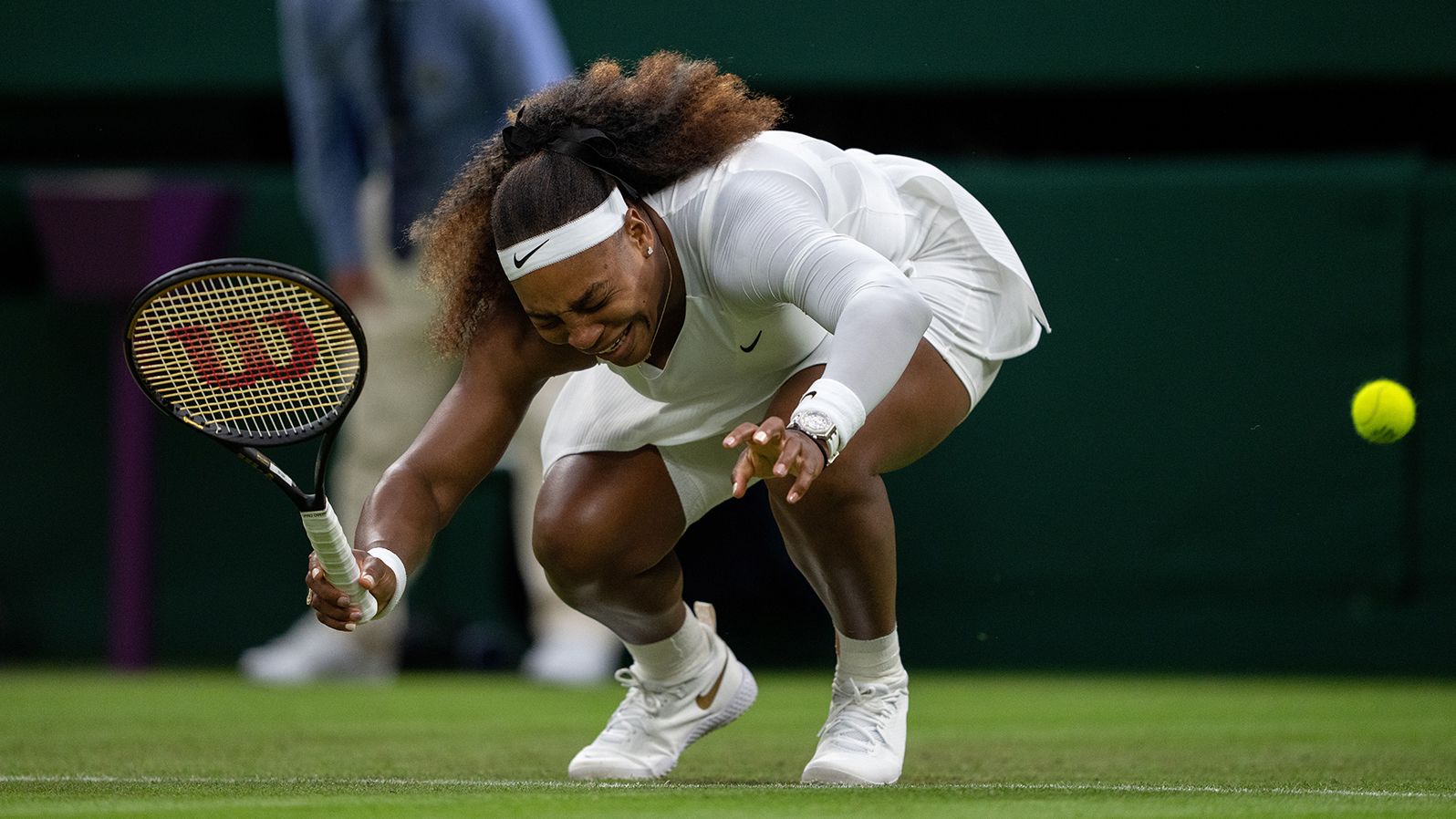 Wiliams winces in pain during a first-round Wimbledon match in 2021. She was forced to retire from the match due to the injury.