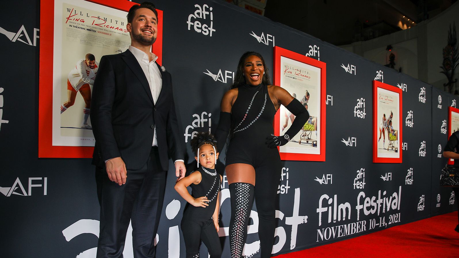 Williams poses with her daughter and husband at a premiere of the film "King Richard" in 2021. The film is based on Williams' father and how he raised his girls to become tennis champions.