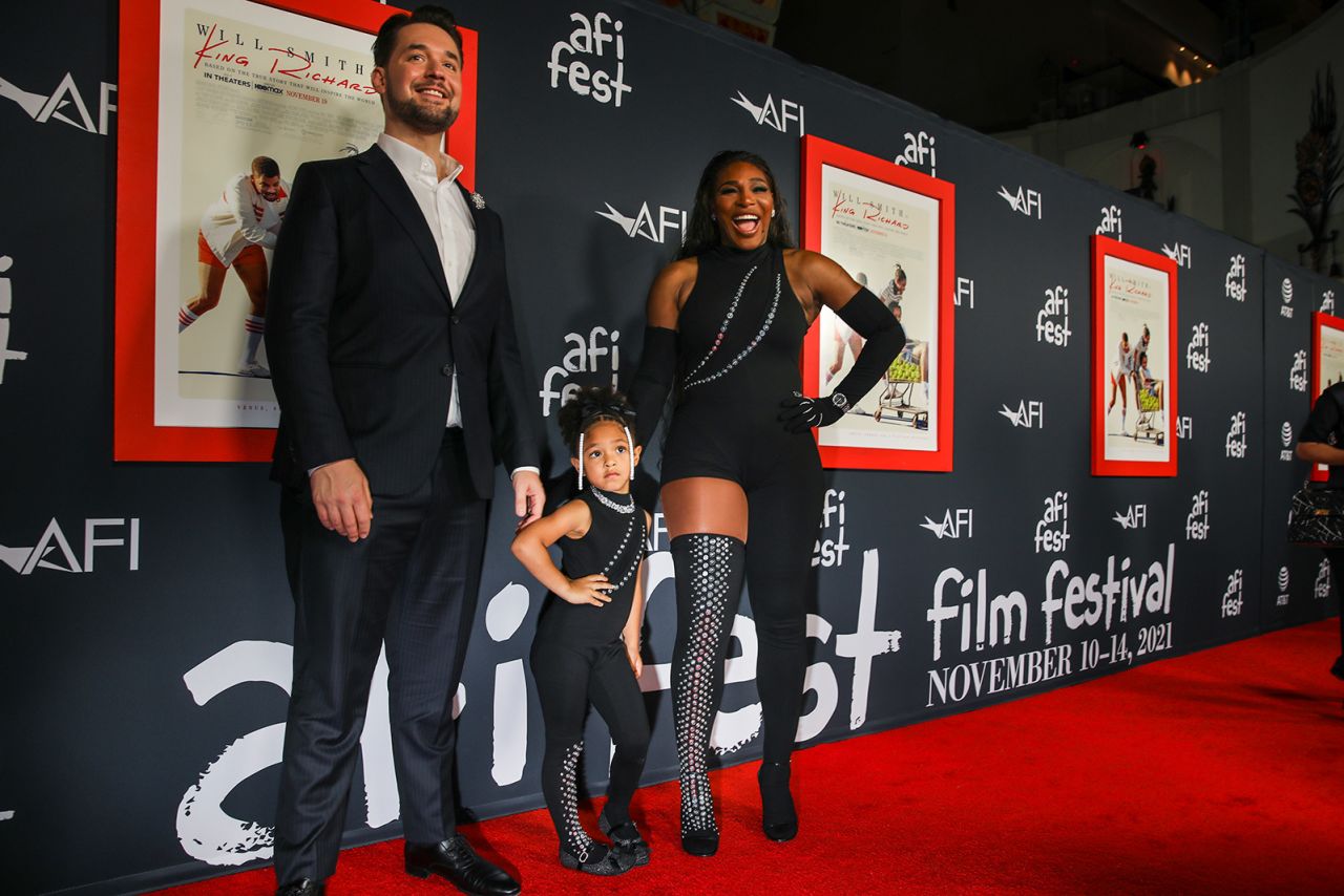 Williams poses with her daughter and husband at a premiere of the film "King Richard" in 2021. The film is based on Williams' father and how he raised his girls to become tennis champions.