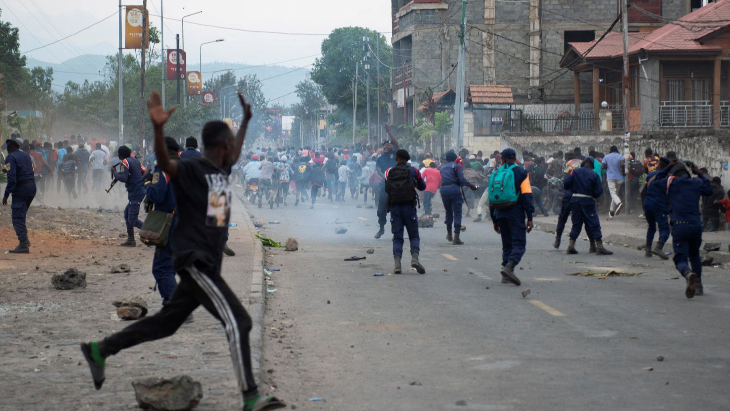Congolese policemen disperse protesters along the road near the compound of a United Nations peacekeeping force's warehouse in Goma in the North Kivu province of the Democratic Republic of Congo July 26, 2022.