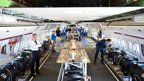 Visitors onboard the 777-9X, a test version of Boeing's 777X, during the Farnborough Airshow in the UK.