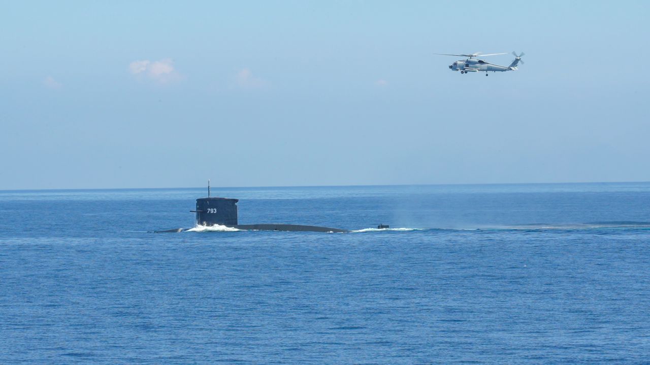 A helicopter and a submarine take part in Taiwan's live-fire military drills on July 26.