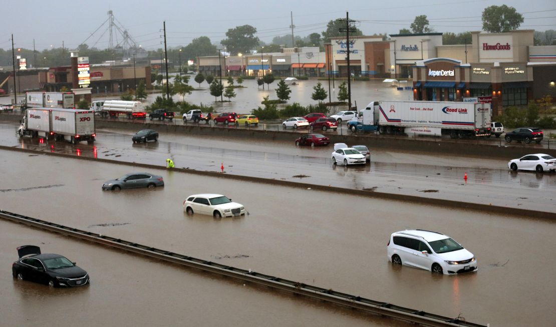Abandoned cars are scattered by flooding across a shuttered section of I-70 Tuesday.