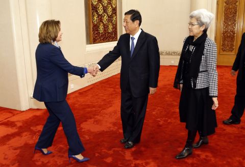 Pelosi shakes hands with Zhang Ping, vice vhairman of China's National People's Congress, as she arrives for a bilateral meeting at the Great Hall of the People in Beijing in November 2015. At right is Fu Ying, head of the NPC's foreign affairs committee.