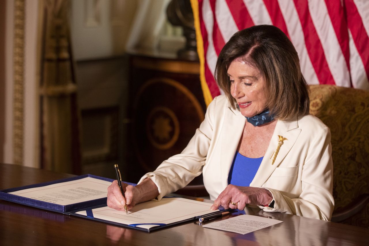 Pelosi signs the Uyghur Human Rights Policy Act in 2020. The bill would impose sanctions on Chinese officials involved in the mass surveillance and detention of Uyghurs and other ethnic groups in the western Xinjiang region.