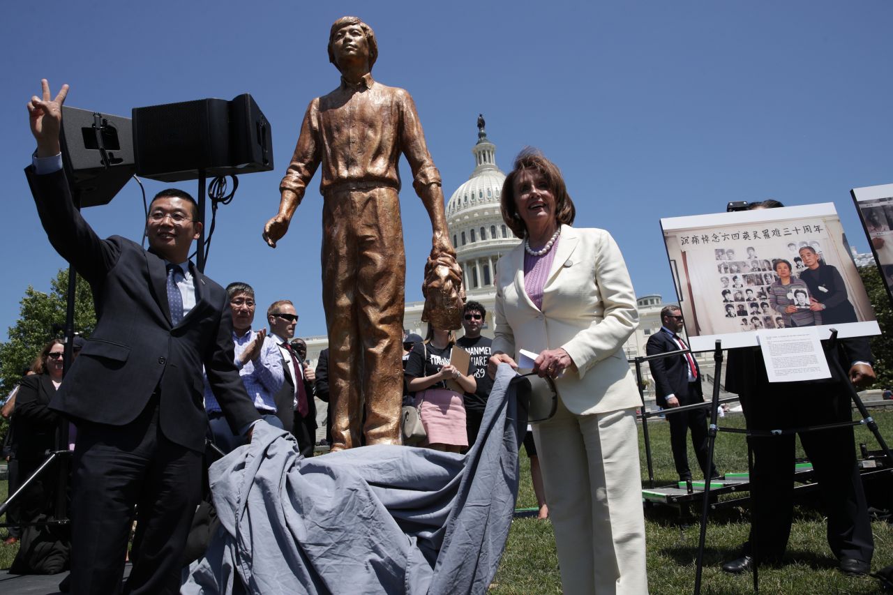 Pelosi and Chinese dissident Yang Jianli unveil the "Tank Man" statue during a 2019 rally in Washington, DC, to mark the 30th anniversary of the Tiananmen Square protests.