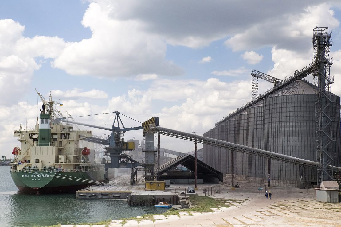 A cargo ship is loaded beside  grain silos in an Odesa port in 2013.