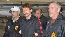 Former Soviet military officer and arms trafficking suspect Viktor Bout (center) deplanes after arriving in New York in November 2010.