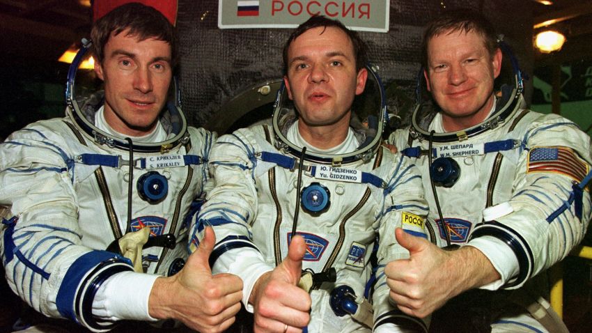 The first crew of the International Space Station (R-L) US astronaut Bill Shepherd and Russian cosmonauts Yuri Gidzenko and Sergei Krikalyov show thumbs up as they sit in their space suits in front of Soyuz TM rocket at Baikonur cosmodrome 19 October 2000. A US and Russian crew due to be the first men to inhabit the $60 billion International Space Station arrived at the Baikonur cosmodrome on Wednesday to inspect the craft on which they are due to fly. (Photo by STR / POOL / AFP) (Photo by STR/POOL/AFP via Getty Images)
