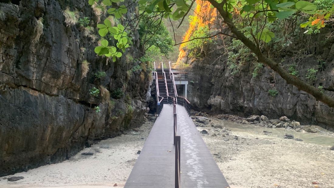 <strong>New boardwalk:</strong> From the jetty, visitors walk down a new boardwalk, which cuts through the forest, to reach the crescent-shaped beach on the other side of the narrow island.