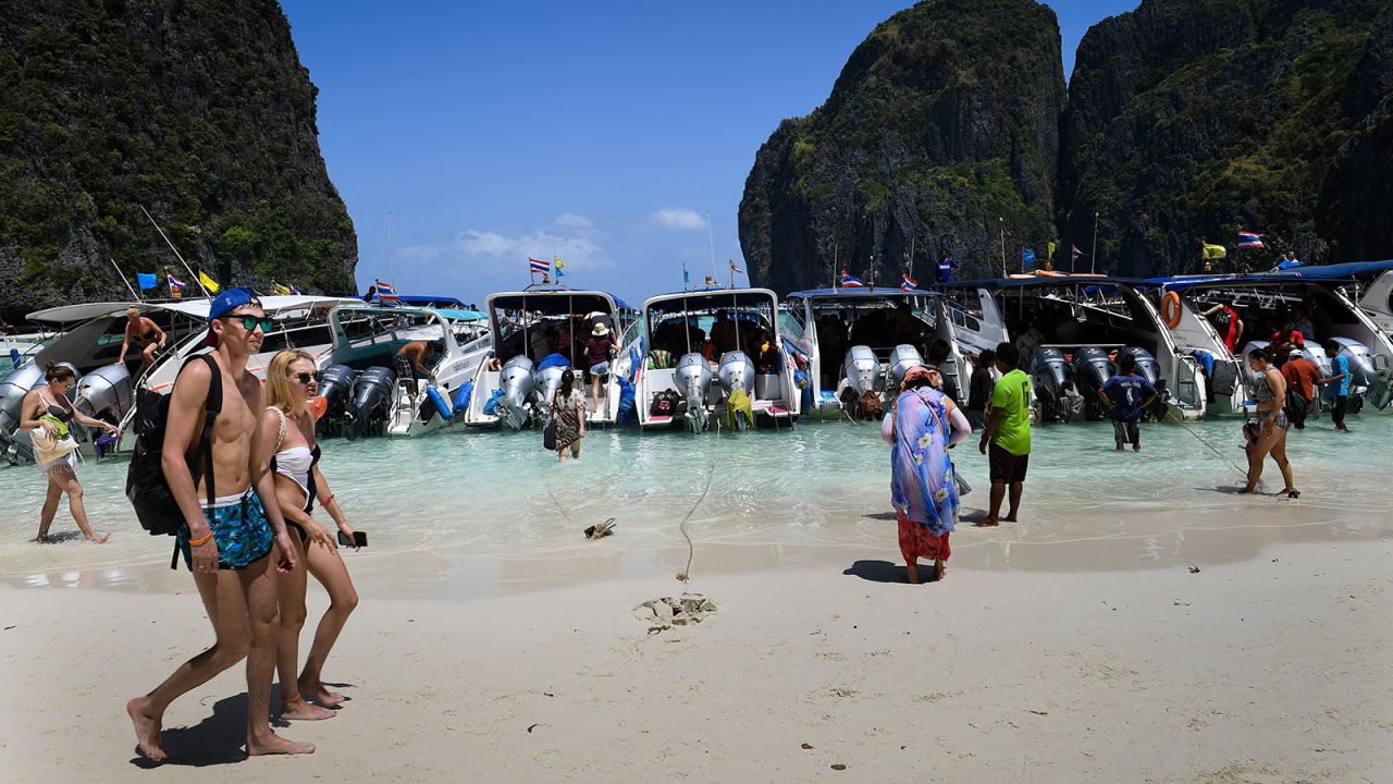 <strong>Loved to death: </strong>As this image taken in 2018 shows, the beach was far from idyllic prior to the closure. Years of overtourism took their toll, with around 5,000 people entering the bay each day at the peak of its popularity.   