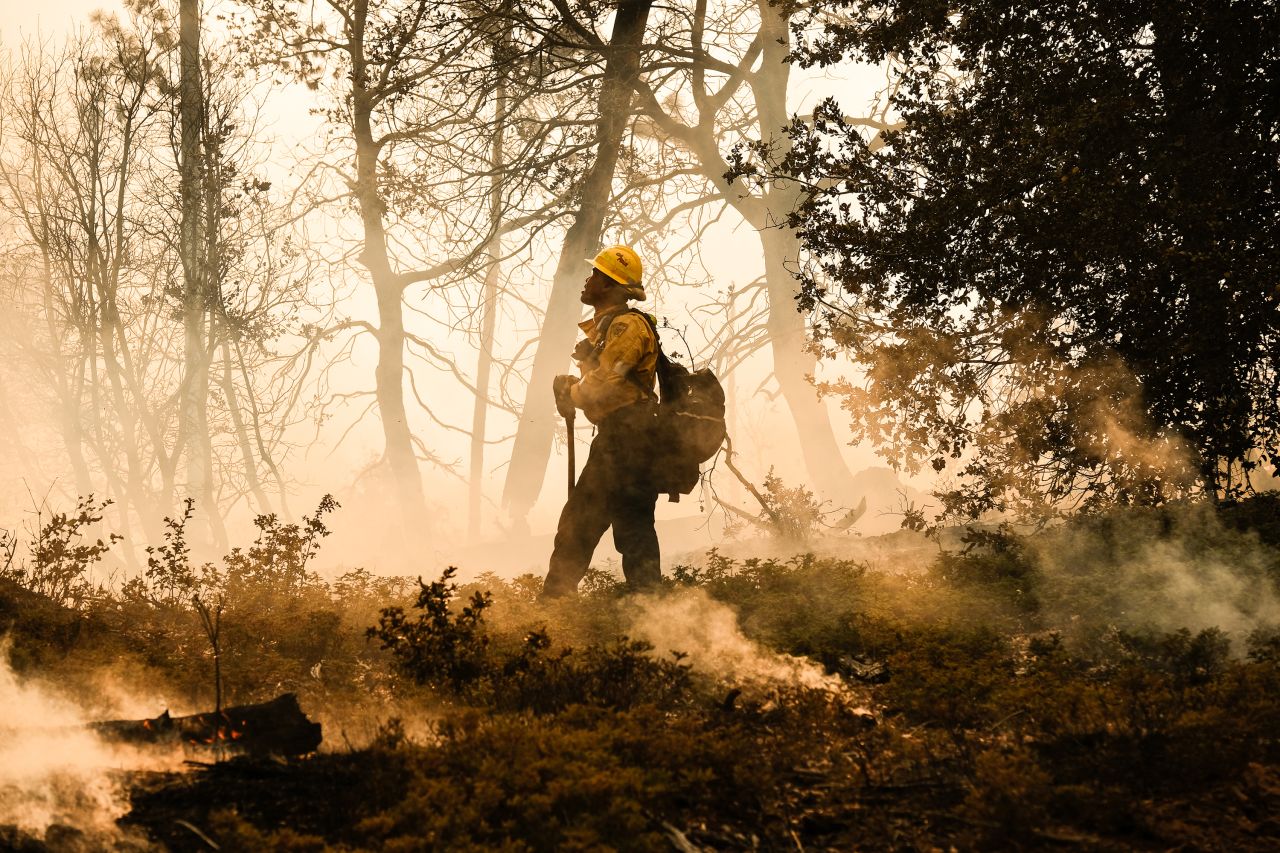 A firefighter monitors a backfire operation in Mariposa County on Sunday.