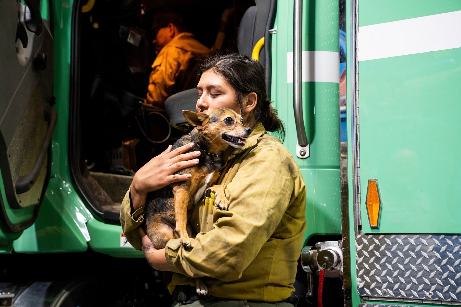 Firefighter Joanna Jimenez holds a dog she found wandering in an evacuation zone on Saturday.