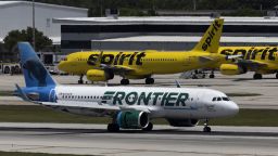 FORT LAUDERDALE, FLORIDA - MAY 16: A Frontier Airlines plane near a Spirit Airlines plane at the Fort Lauderdale-Hollywood International Airport on May 16, 2022 in Fort Lauderdale, Florida. JetBlue announced it is taking a hostile position in its effort to acquire Spirit Airlines. Spirit previously rejected a takeover offer from JetBlue, favoring an earlier deal to merge with Frontier airlines. (Photo by Joe Raedle/Getty Images)