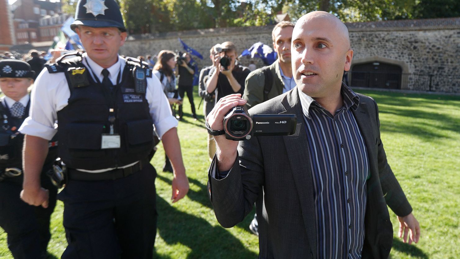 Blogger Graham Phillips is escorted away by police officers after he disrupted a press conference by Bellingcat founder Eliot Higgins, report author Christo Grozev and MP Bob Seely opposite the Houses of Parliament in London, Britain, October 9, 2018. 