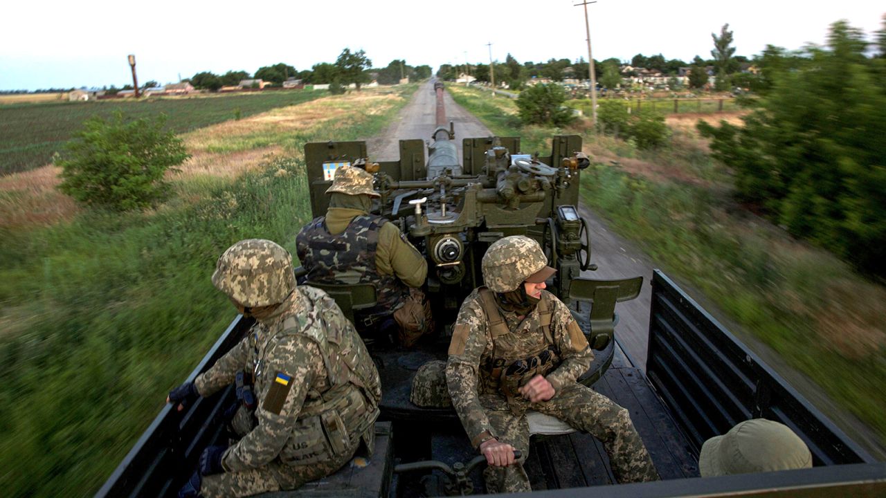 Ukrainian servicemen ride through Mykolaiv region in mid-June.