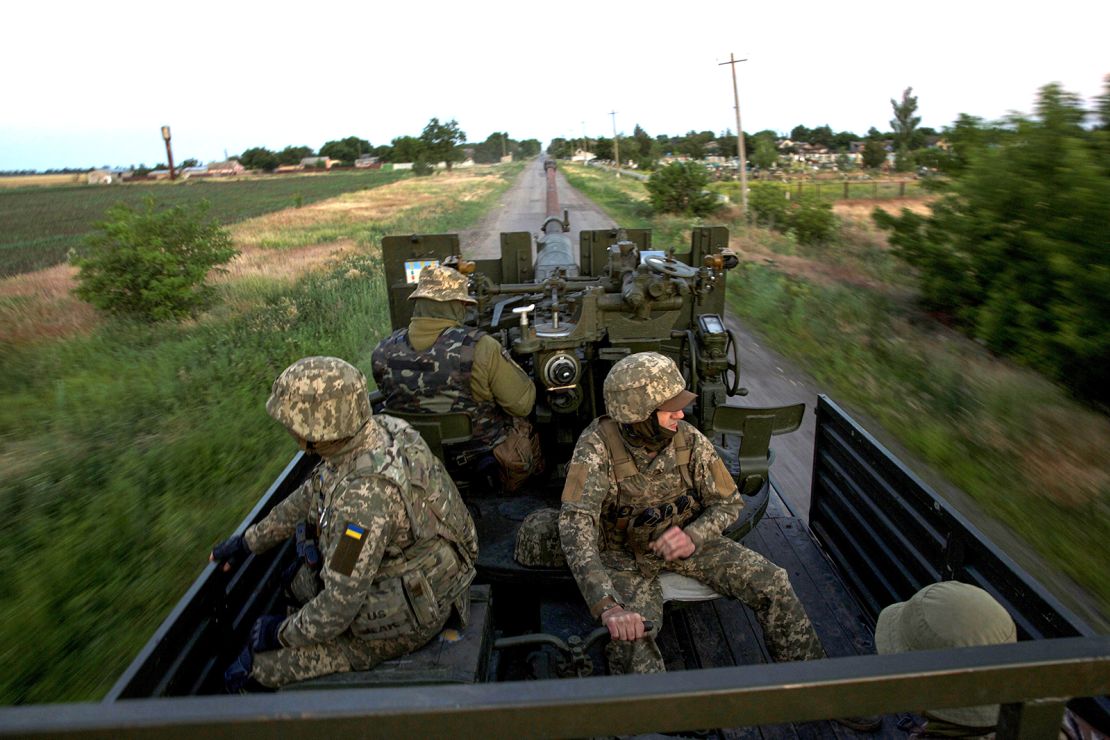 Ukrainian servicemen ride through Mykolaiv region in mid-June.