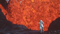 Katia Krafft wearing aluminized suit standing near lava burst at Krafla Volcano, Iceland. (Credit: Image'Est)