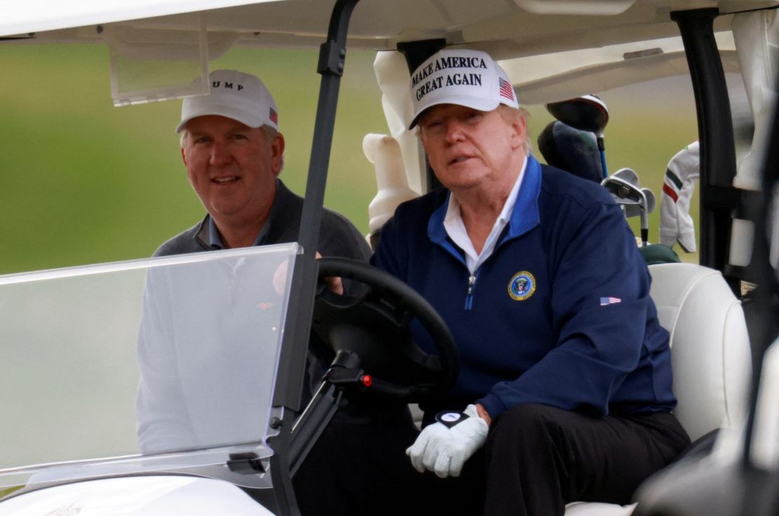 Trump drives a golf cart at the Trump National Golf Club in Sterling, Virginia.