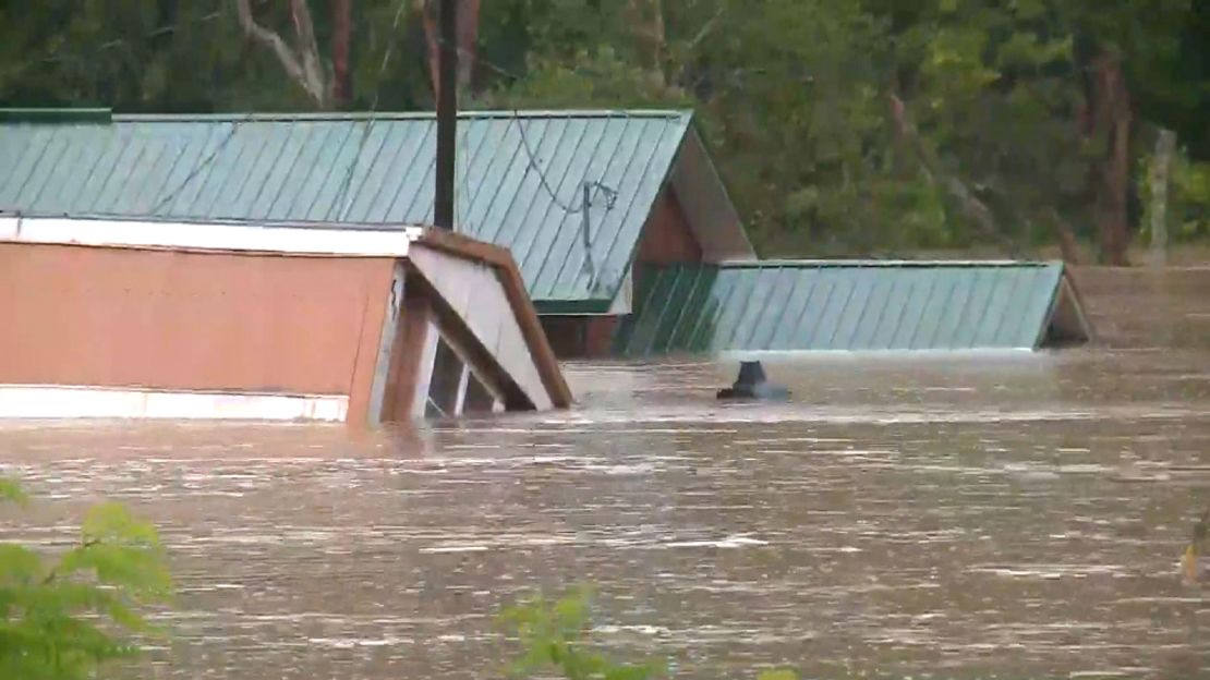 Water nearly swallows some buildings Thursday morning in the community of Lost Creek in eastern Kentucky's Breathitt County.
