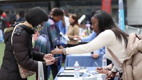 A job seeker meets with a recruiter during the Healthcare Academy career and training fair outside of the Chase Center on June 03, 2022 in San Francisco, California. 