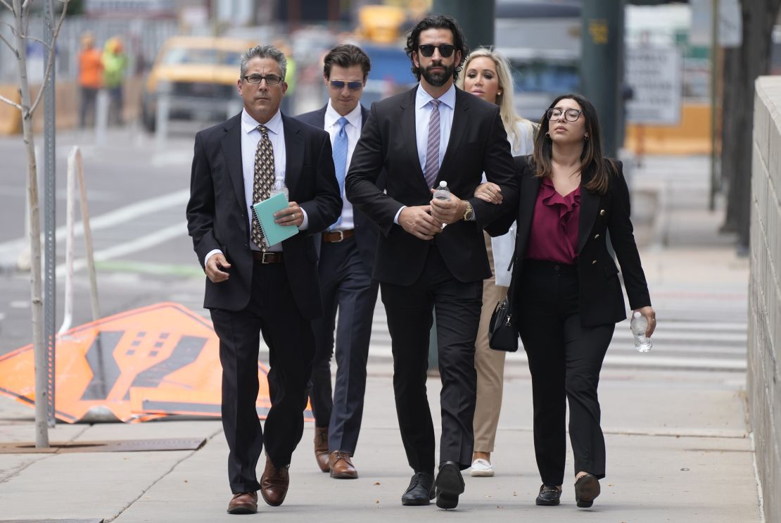 Lawrence Rudolph's defense investigator, left, heads into federal court in Denver along with the dentist's children.