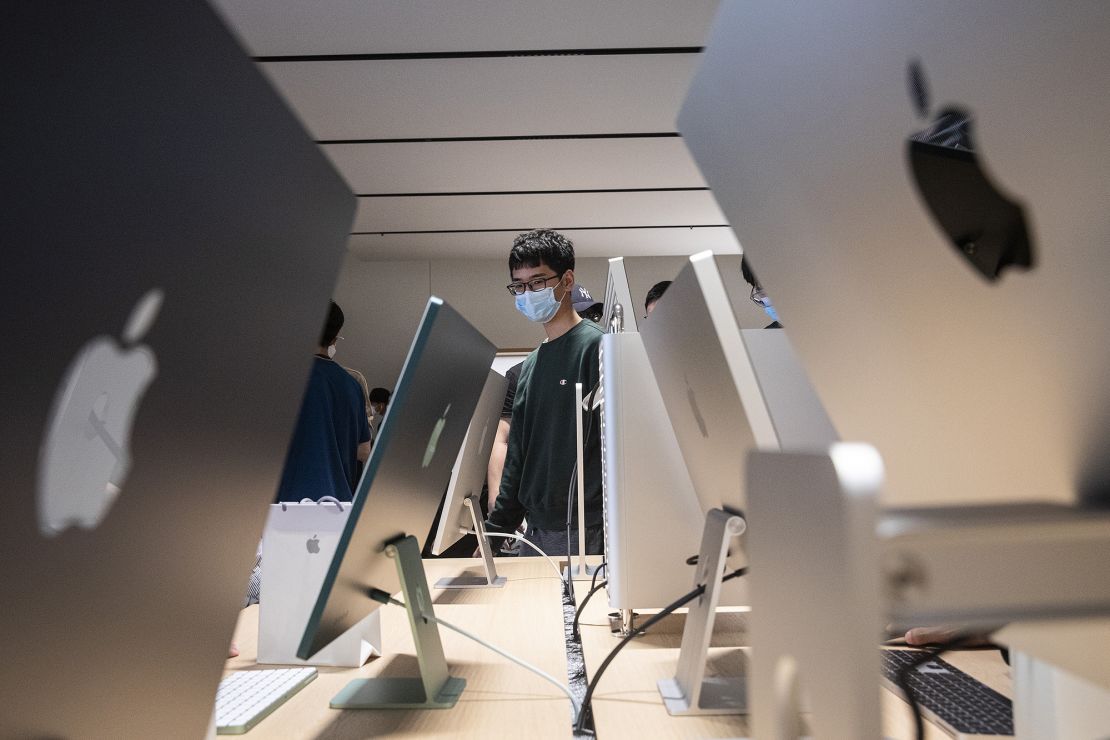 Customers interact with Apple products at the new Apple retail store at Wuhan International Plaza on May 21, 2022.