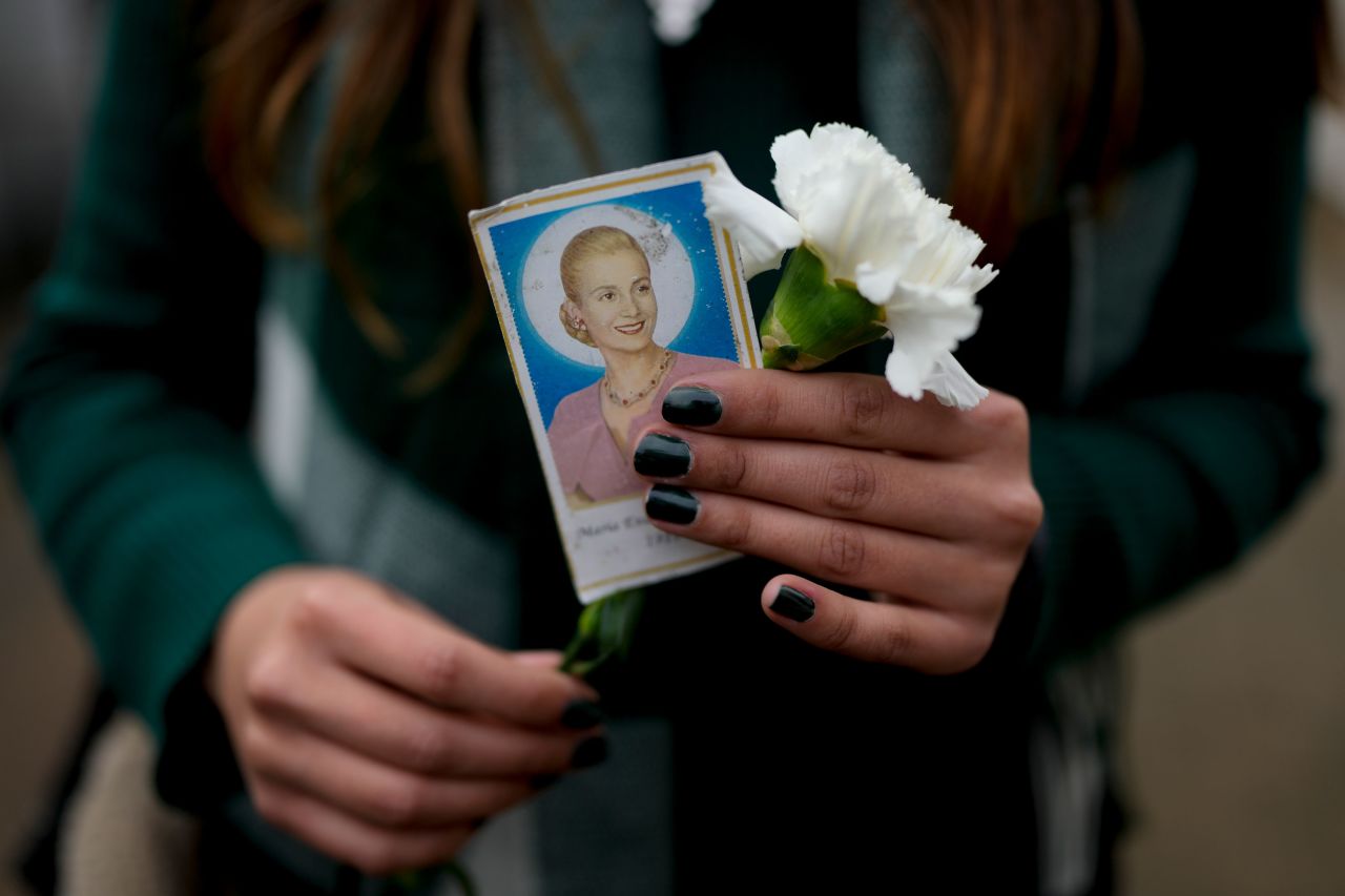 A woman in Buenos Aires holds a photo of Maria Eva Duarte de Perón, <a href="https://www.cnn.com/2012/07/26/world/americas/argentina-evita-money/index.html" target="_blank">Argentina's most famous first lady,</a> as she waits to visit her tomb on the 70th anniversary of her death on Tuesday, July 26. Eva Perón, better known by her nickname Evita, championed the rights of the poor, pushed for more social programs and argued for women's suffrage. She died of cancer at the age of 33.