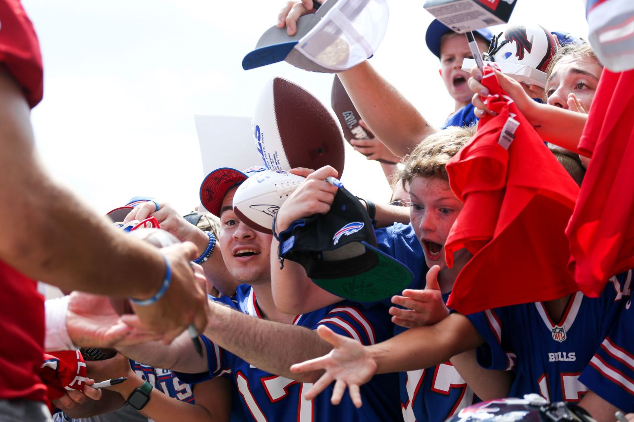 Young fans get autographs from Buffalo quarterback Josh Allen while attending the NFL team's training camp in Pittsford, New York, on Monday, July 25.
