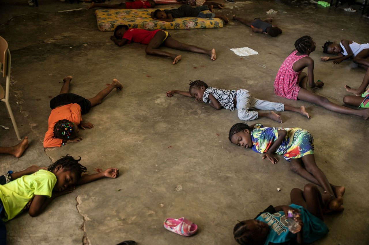 Children in Port-au-Prince, Haiti, sleep on the floor of a school turned into a shelter on Saturday, July 23, after they were forced to leave their homes because of gang clashes in the area.