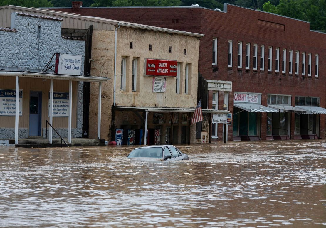 A car is submerged in flood waters along Right Beaver Creek following a day of heavy rain in in Garrett, Kentucky.