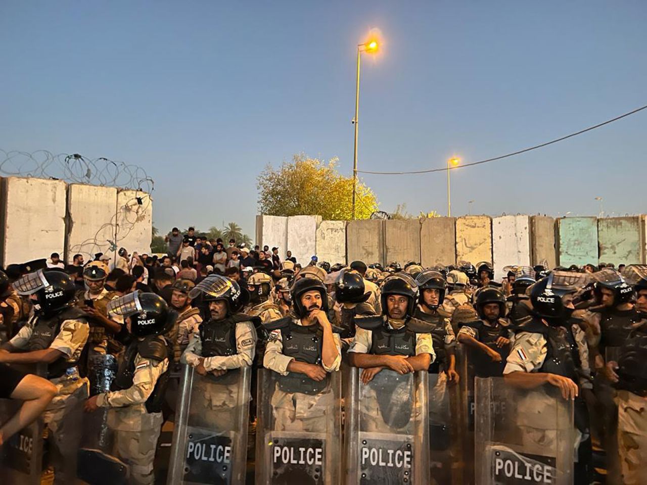 Security forces stand in front of Iraq's Parliament after hundreds of angry protesters, loyal to the powerful cleric Muqtada al-Sadr, <a href="https://www.cnn.com/2022/07/27/middleeast/iraq-protests-baghdad-green-zone-intl/index.html" target="_blank">broke into Baghdad's heavily protected Green Zone</a> on Wednesday, July 27, to denounce the nomination of a new prime minister. Al-Sadr told protesters at the Parliament building that their "message" had been received and that they should return home.