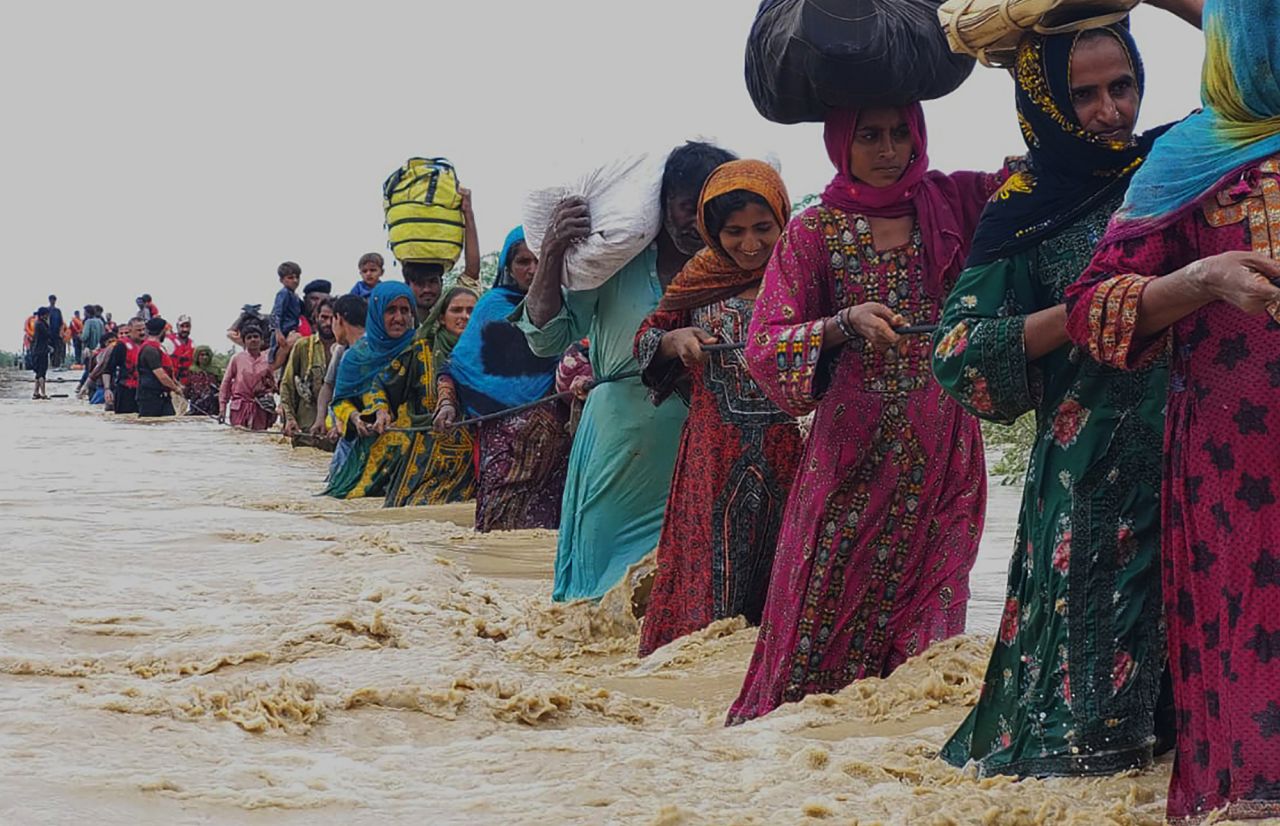 Villagers evacuate a flooded area in Lasbella, Pakistan, on Tuesday, July 26. <a href="https://www.cnn.com/2022/07/25/asia/pakistan-karachi-torrential-rain-climate-crisis-intl-hnk/index.html" target="_blank">Torrential rains</a> caused deadly flooding and infrastructure damage.