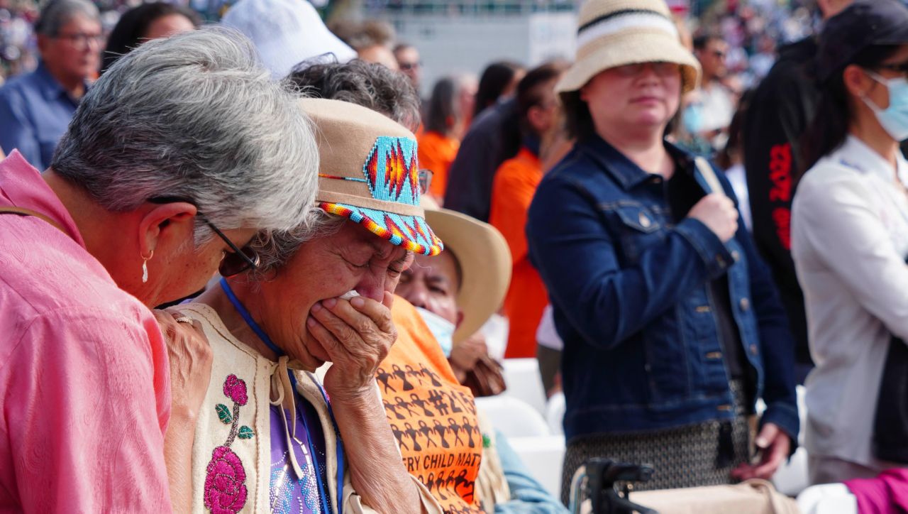 A woman becomes emotional on Tuesday, July 26, as Pope Francis holds Mass at Commonwealth Stadium in Edmonton, Alberta.