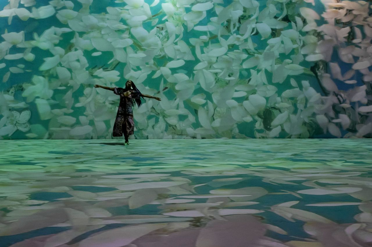 A guest dances Wednesday, July 27, in Van Gogh Alive, a multimedia exhibition in Rio de Janeiro featuring projections of paintings by Dutch artist Vincent van Gogh.