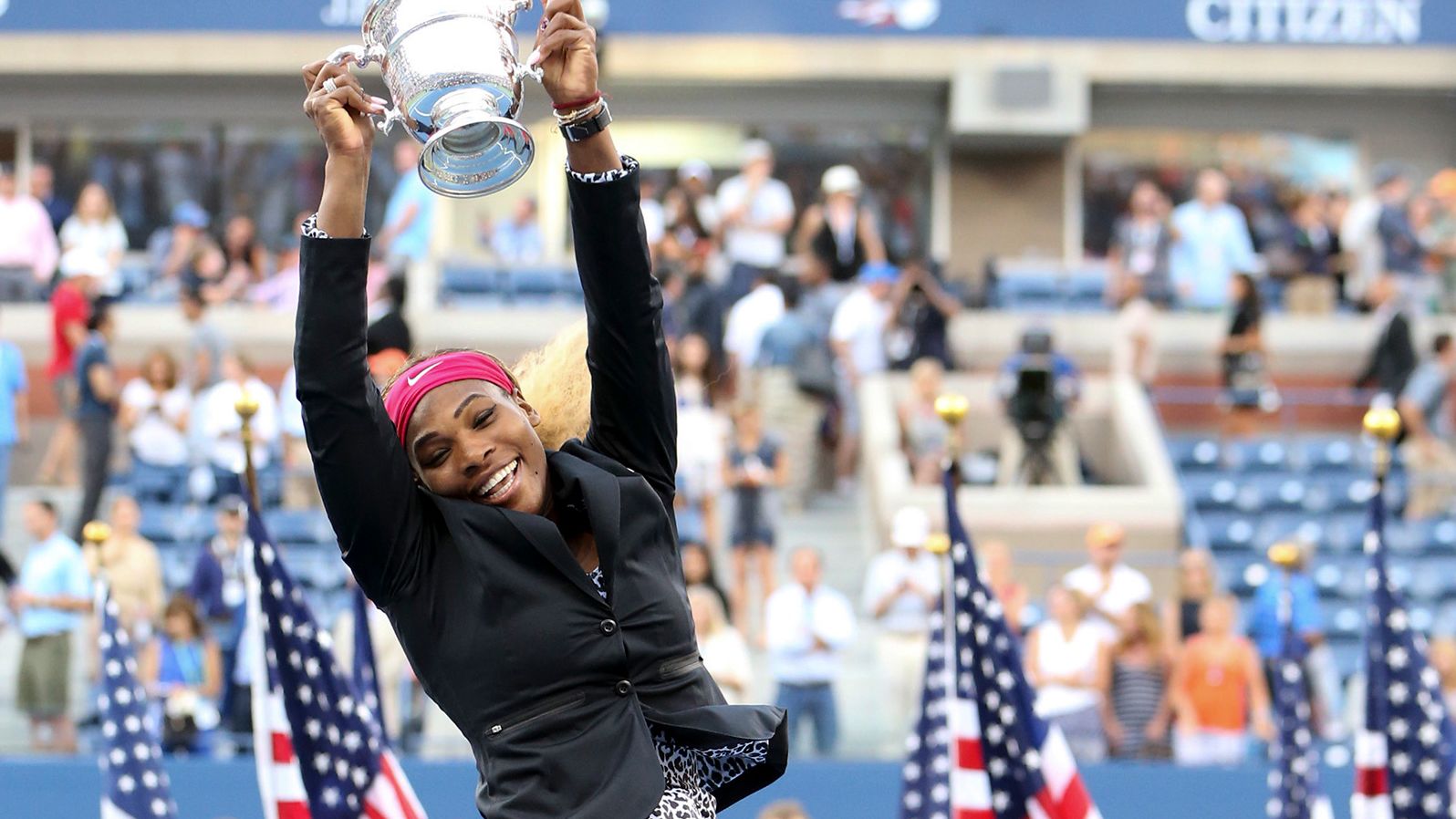 Williams jumps with the trophy after winning the US Open in 2014.