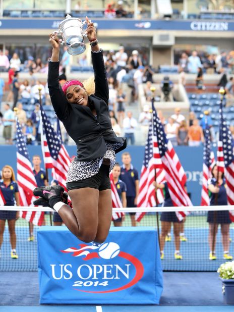 Williams jumps with the trophy after winning the US Open in 2014.