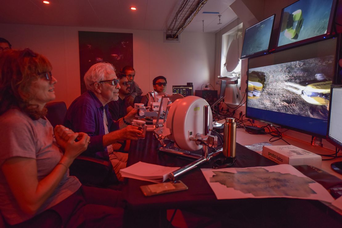 Stanford University roboticist Oussama Khatib (second from left) was able to feel sensations in his hands using the robot's feedback system.