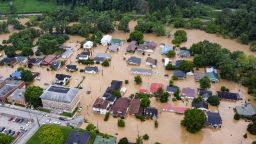 Aerial view of homes submerged under flood waters from the North Fork of the Kentucky River in Jackson, Kentucky, on July 28, 2022. - Flash flooding caused by torrential rains has killed at least eight people in eastern Kentucky and left some residents stranded on rooftops and in trees, the governor of the south-central US state said Thursday. 