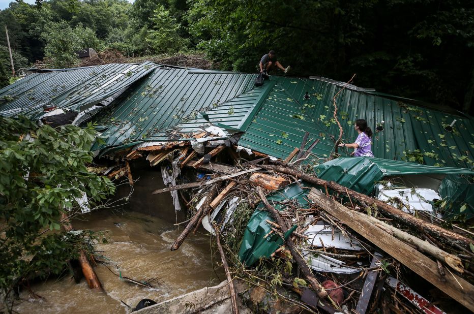 Kermit Clemons helps his ex-wife, Lana Clemons, retrieve family items in Hazard, Kentucky, on Thursday.