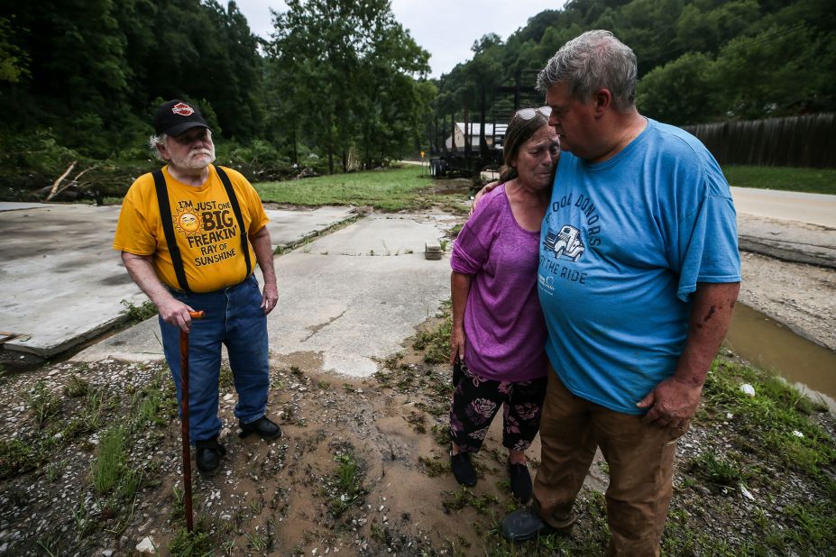 Pastor Pete Youmans consoles a tearful Debby Miniard as her father, Charles Blankenship, stands near where his garage used to be in Perry County. Blankenship lost everything, including his trailer home.