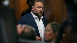 Alex Jones walks into the courtroom in front of Scarlett Lewis and Neil Heslin, the parents of 6-year-old Sand Hook shooting victim Jesse Lewis, at the Travis County Courthouse in Austin, Texas, U.S. July 28, 2022. Jones had been found to have defamed the parents of a Sandy Hook student for calling the attack a hoax, and the parents are seeking $150 million in compensatory and punitive damages for what they say was a campaign of harassment and death threats by Jones' followers.