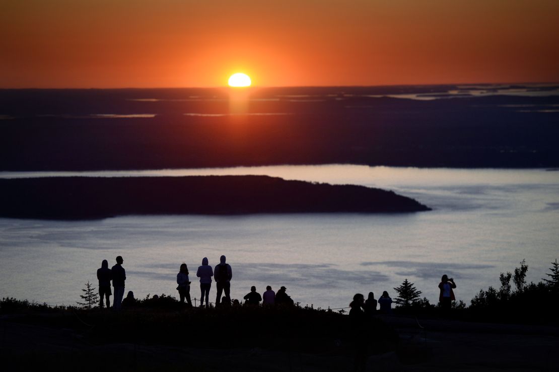 Visitors flock to Cadillac Mountain in Acadia National Park in Maine to watch the sunrise. 