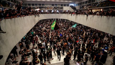 Protesters cheer after entering Iraq's parliament on Saturday.